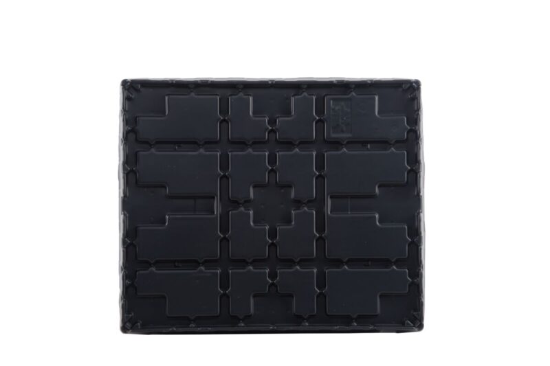 A black plastic pallet with a pattern on it.