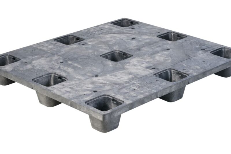 A gray plastic pallet with four holes.