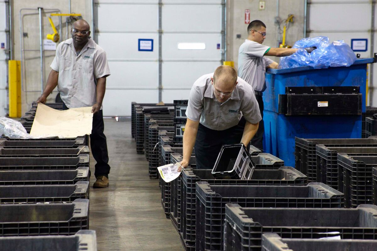 Picture of associates cleaning collapsible bulk containers in ORBIS RPM facility