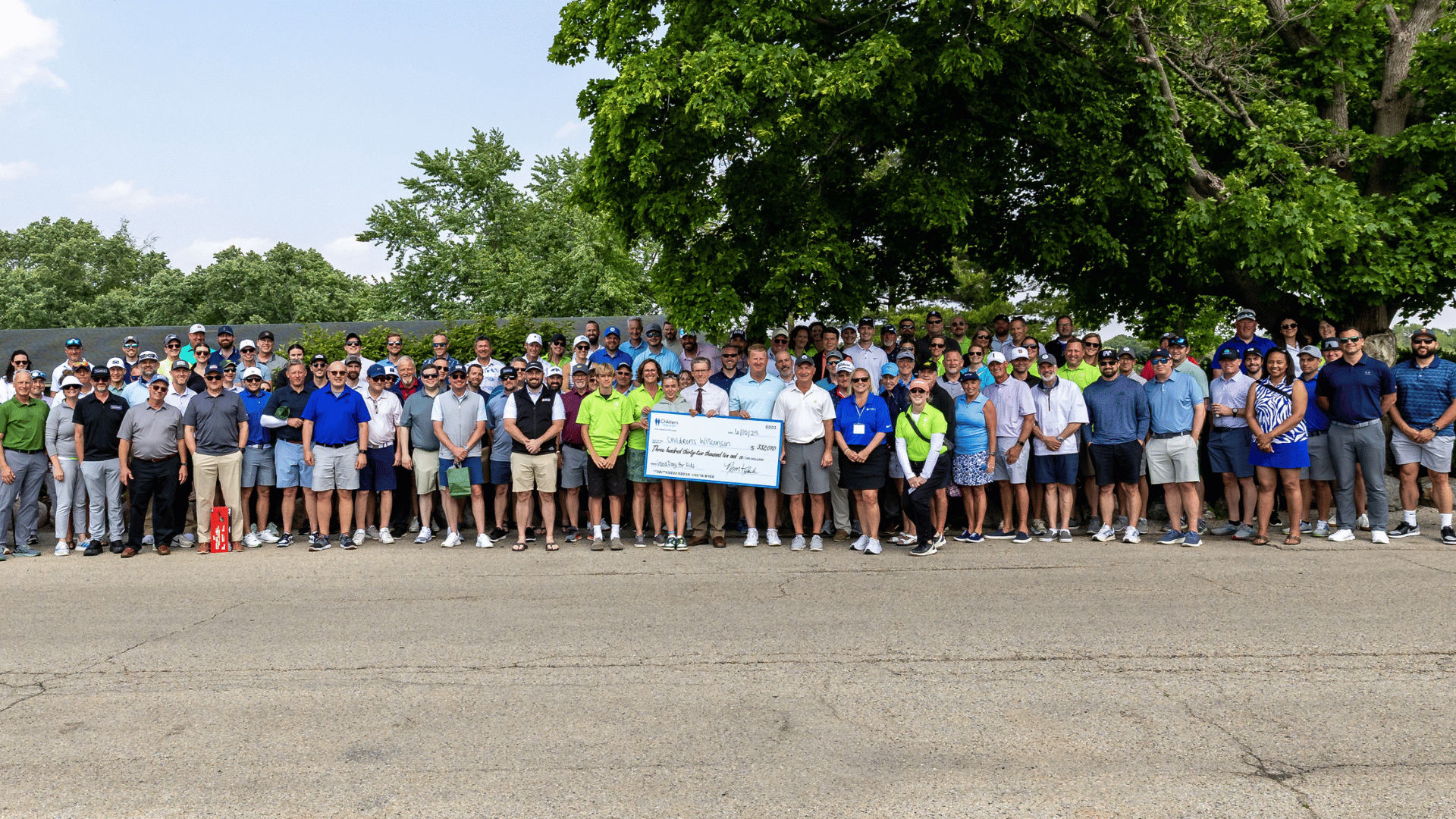 A large group of volunteers at a golf course for ORBIS' Good Days For Kids 2025